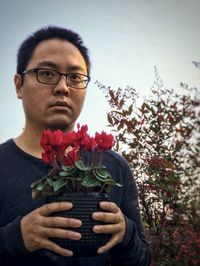 Portrait of man holding flower