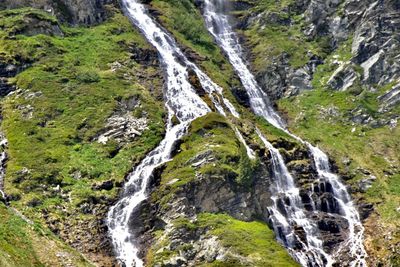 Scenic view of waterfalls in mountains