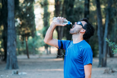 Midsection of man drinking glass