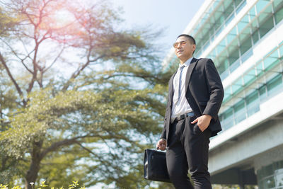 Low angle view of young man looking away