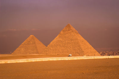 View of desert against sky showing giza pyramids 