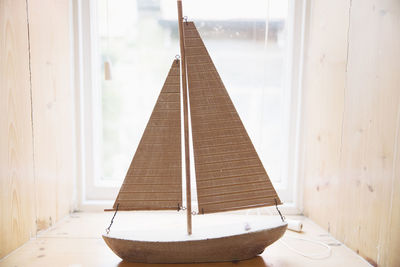 Wooden boat on window sill at home