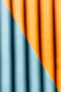 Abstract background from orange and blue color with curve shadows on it