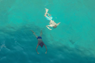 High angle view of people swimming in sea