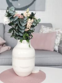 Close-up of white roses in vase on table