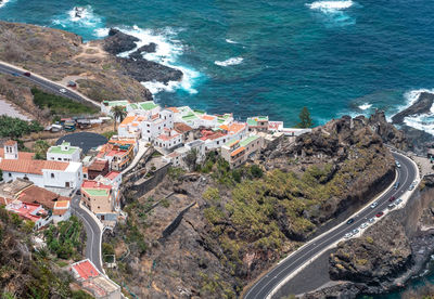 High angle view of townscape by sea against sky