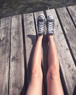 Low section of woman standing on wood
