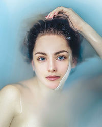 Portrait of shirtless man in bathroom