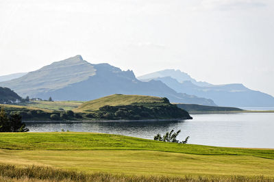 Scenic view of lake and mountains against sky