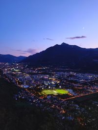 High angle view of illuminated buildings in town against sky