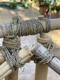 Close-up of ropes tied on wood