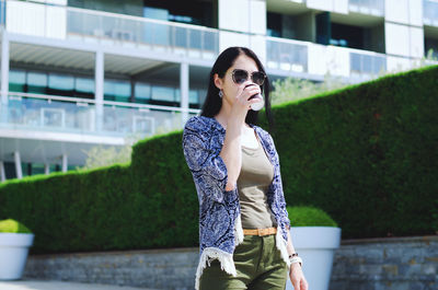 Young happy business woman relaxing in city, outdoor cafe. drinking coffee. using phone. summer