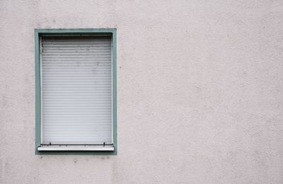 Closed window of white building