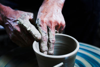 Close-up of artist making pot at workshop