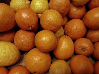 Full frame shot of lemons and orange for sale