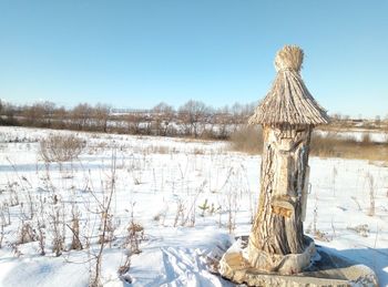 Snow covered land and beehive against clear sky during winter, folk taming beehives
.