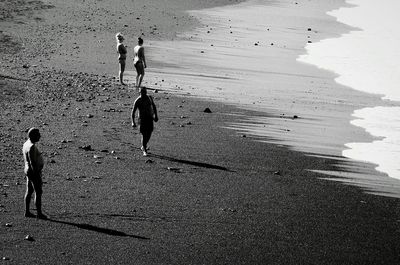 Silhouette men on beach