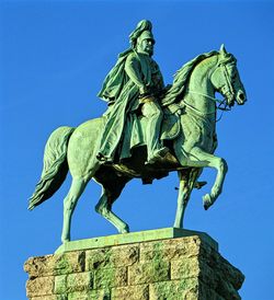 Low angle view of statue against clear blue sky