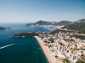 High angle view of townscape by sea against sky