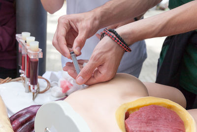 Rescue worker injecting mannequin