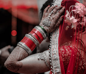 Midsection of woman with red umbrella