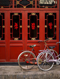 Bicycle parked against building in city