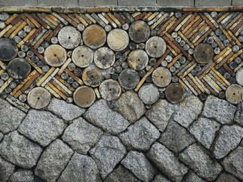 High angle view of logs on cobblestone street