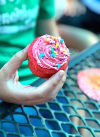 Close-up of human hand holding ice cream