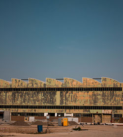 Factory against clear blue sky