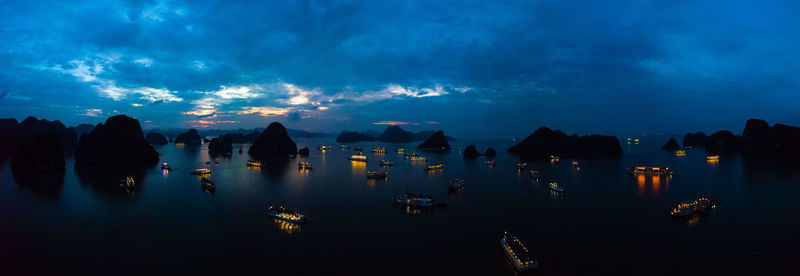 Panoramic view of city lit up at dusk