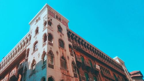 Low angle view of historical building against blue sky