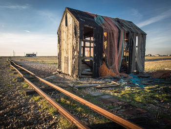 Abandoned railroad tracks against sky