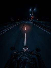 Man riding motorbike on road at night