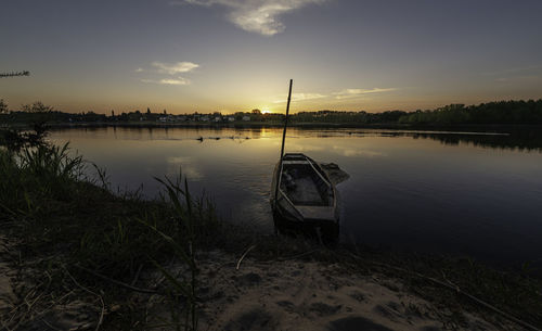 Scenic view of lake against sky during sunset