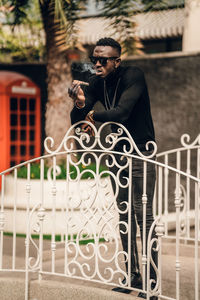 Man standing by railing