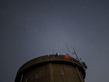 Low angle view of building against sky at night