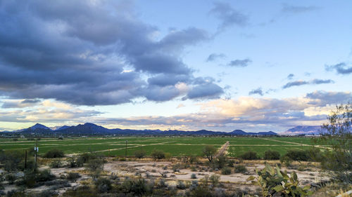 Scenic view of landscape against cloudy sky