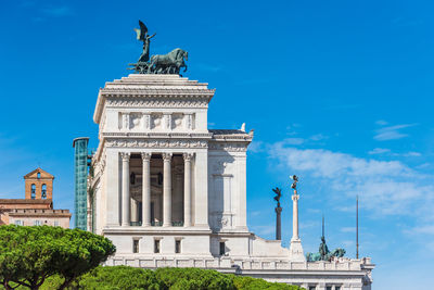 Low angle view of statue against blue sky