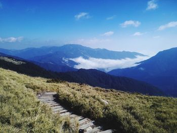 Scenic view of mountains against blue sky