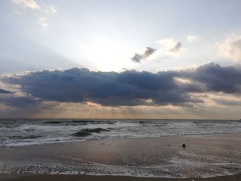 Scenic view of beach against sky during sunset