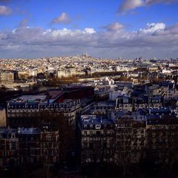 High angle view of cityscape against cloudy sky