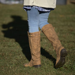 Low section of man standing on field