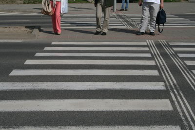 Low section of people walking on road