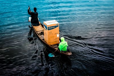 Rear view of man in boat at sea