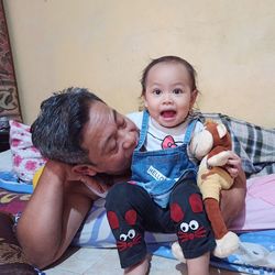 Portrait of mother and daughter at home