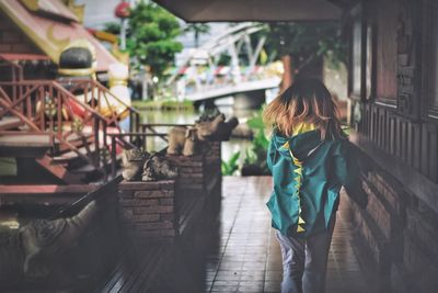 Rear view of woman walking in market