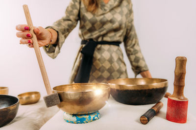 Woman playing tibetan singing bowl in sound healing therapy