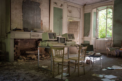 Chairs and table in abandoned room