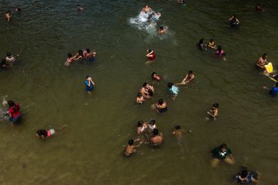 High angle view of people swimming in lake