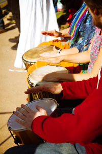 Cropped image of street musicians playing drums on street